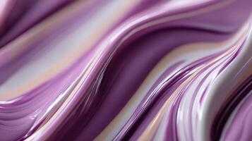 Smooth purple paint swirls on a canvas creating waves photo