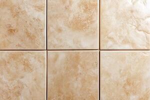 Neutral beige ceramic tiles arranged in a grid pattern photo