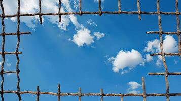 A wooden fence with a blue sky and clouds photo
