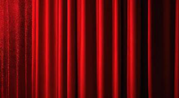 A red curtain is shown in front of a black background photo