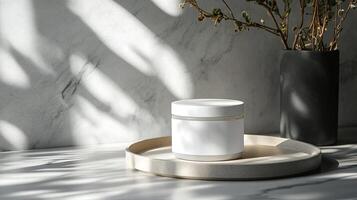 A jar of cream sits on a tray next to a vase photo