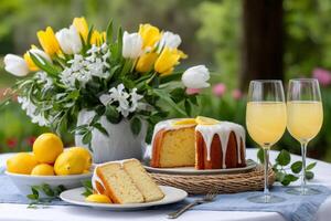 Lemon cake with icing and lemonade on table enjoying spring garden photo