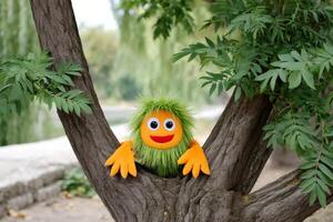 Funny puppet hugging a tree in a park during a sunny summer day photo