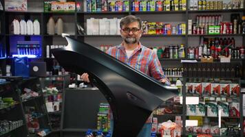 Senior Driver Choosing a Car Fender in Auto Shop video