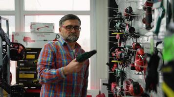 Senior Man Selecting Power Tool in Hardware Store video