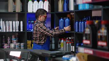Senior Auto Parts Clerk Arranging Oil Bottles on Shelf video
