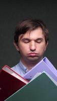 vertical close-up Office worker struggling with stack of binders and files video