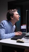 vertical Office worker with bad posture typing on keyboard and looking at computer screen video