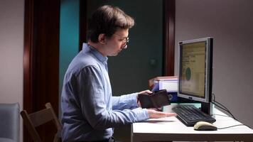 Businessman finding empty wallet at office desk showing financial problems video