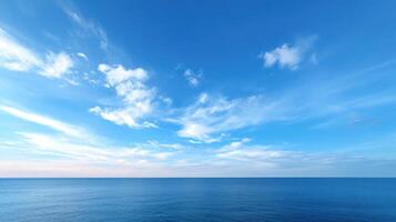 Bright blue ocean horizon and clear sky with white clouds showing calm open seascape, peaceful atmosphere, and vibrant natural beauty under sunny weather. photo
