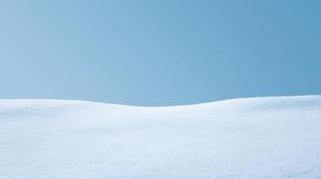 Pure white snow landscape under clear blue sky capturing smooth snow surface with bright sunlight and minimal winter scenery in cold crisp atmosphere. photo