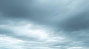 Gray overcast sky with thick cloud cover creating a moody, dramatic, and heavy atmosphere ideal for weather, storm, and natural landscape themes. photo