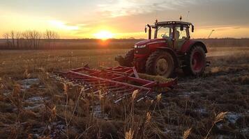 Sunset tractor harvesting, rural farming scene with red tractor on wheat field photo
