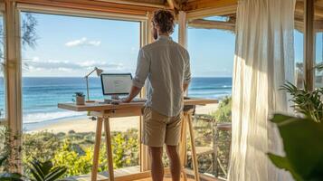 Young caucasian male working remotely from beachfront home office with ocean view photo