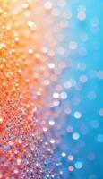 An abstract background with orange glitter on the left and blue bokeh on the right, creating a vibrant and sparkling effect photo