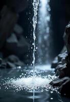 Water falling from a cave ceiling into a pool of water, rocks and cave in the background, dramatic lighting photo