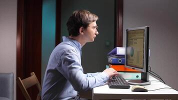 Office worker analyzing charts on computer screen at night video