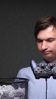 vertical close-up Office worker throwing gamepad into trash can video