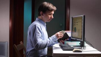 Office worker counting last money in wallet at night video