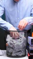 vertical Businessman searching through trash bin for documents video