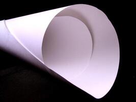 White paper roll over black background creative background photo