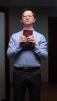 vertical Religious man praying with closed eyes and holding holy book video