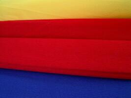 Red, yellow and blue paper pieces close view background wallpaper photo