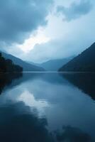 Calm Mountain Lake under Cloudy Sky photo