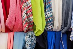 Colorful fabrics hanging in a store, showcasing a variety of textures and patterns photo