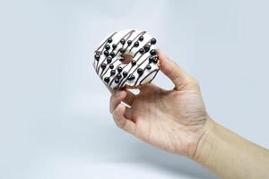 vanilla donuts with choco chips on hold photo