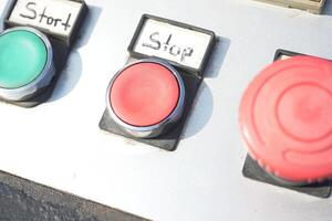 Control panel with start and stop buttons in industrial setting photo