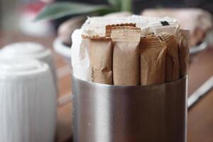Collection of sugar packets in a diner setting on a wooden table photo