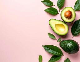 Avocado with leaves on pastel pink background with free copy space for text photo