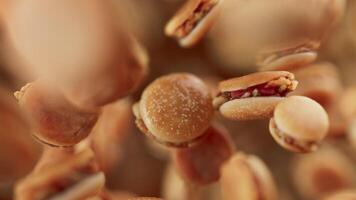 Animation of a group of burgers. Many burgers slowly rotate in the background in space. Horizontal composition. Defocus. Close-up. video