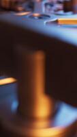 Looping animation of a mechanical structure made of metal gears. Cyclic movement. Vertical composition. Defocus. video