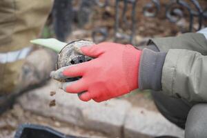 Gardening activity featuring a person using a tool in a garden photo