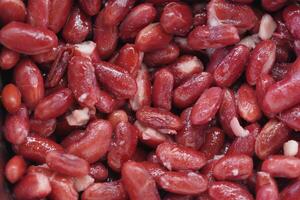 Red kidney beans in a close-up display of texture and color photo