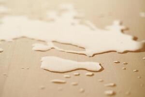 Spilled water on a wooden surface photo