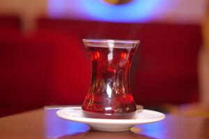 Warm cup of turkish tea on a table in a cozy setting photo