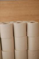 Stacked rolls of natural bathroom tissue in a cozy setting photo