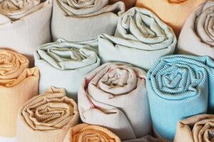 Elegant fabric rolls in soft colors create a charming display photo