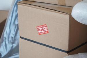 Handling fragile boxes with care during a move in a new home photo