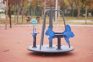 Bright blue rabbit-shaped merry-go-round in a park playground photo