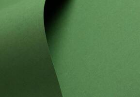 Matte designer paper texture with smooth, curved folds and waves. Elegant, clean surface in soft photo