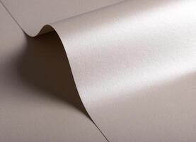 Paper background with satin pearlescent texture. Glossy folded curves, soft wave and sculptural flow photo