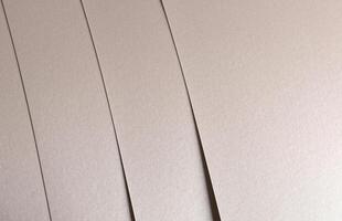 Paper background with satin pearlescent texture. Glossy vertical strips, soft shimmer, pale gold and photo