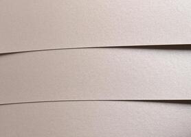 Paper background with satin pearlescent texture. Matte folded horizontal strips, smooth layered photo