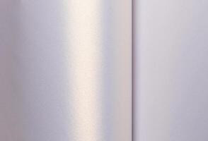 Background with satin paper texture. Glossy folded surface with pearlescent gradient in lavender, photo