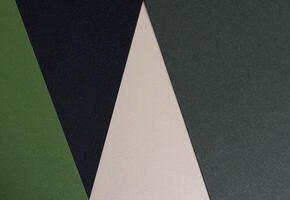 Paper background with matte texture. Layered diagonal sheets in pine green, mint green, champagne, photo