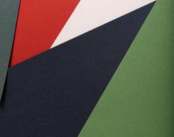 Paper background with matte texture. Layered geometric sheets in crimson red, pastel green, soft photo